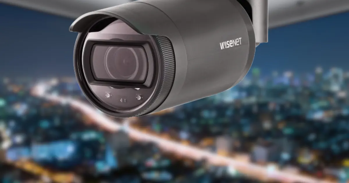 Wisenet Cameras: Night Vision Setup (Wisenet security camera mounted outdoors at night, overlooking a city skyline) | Esentia Systems Wisenet Cameras: Night Vision Setup (Wisenet security camera mounted outdoors at night, overlooking a city skyline) | Esentia Systems